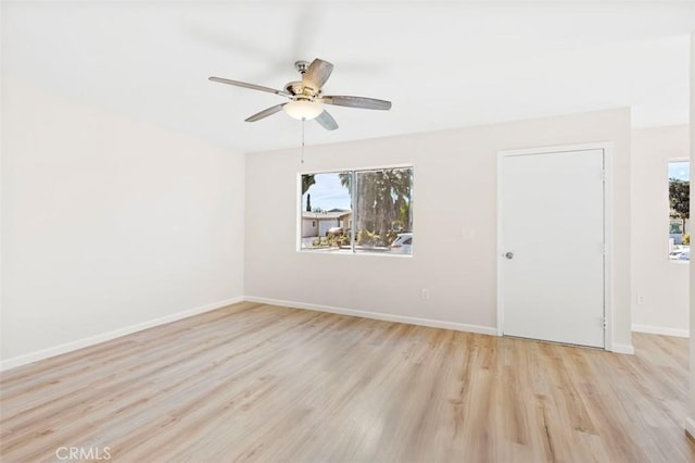 empty room featuring ceiling fan and light hardwood / wood-style flooring