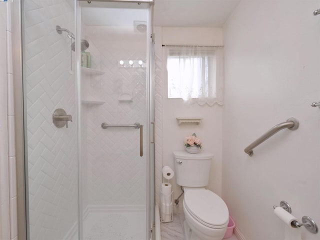 bathroom featuring toilet and walk in shower