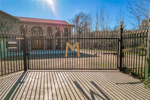 view of gate with fence