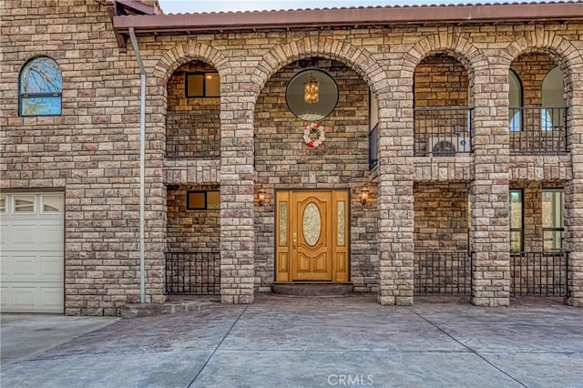 view of exterior entry with a garage