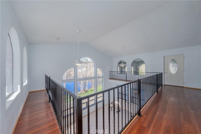 corridor with lofted ceiling and dark wood-type flooring