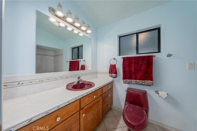 bathroom featuring tile patterned floors, vanity, and a textured ceiling