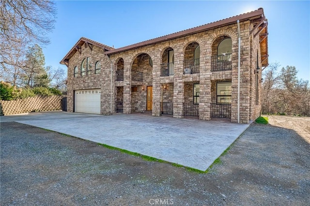 15796 Joseph Trl, Lower Lake, CA 95457 - view of front of home with driveway, a garage, stone siding, and a balcony