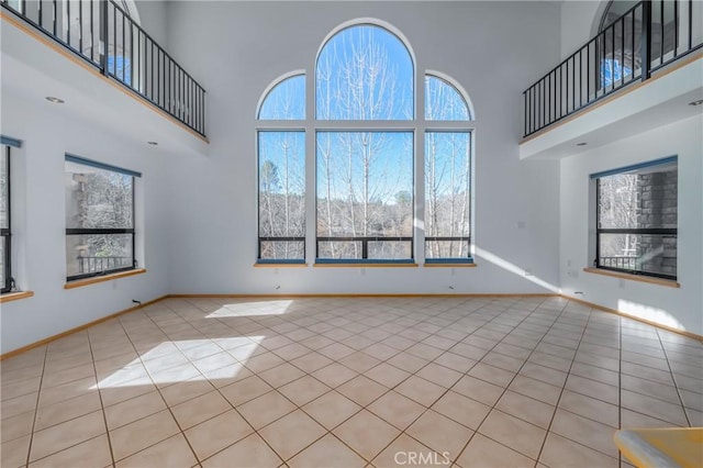 15796 Joseph Trl, Lower Lake, CA 95457 - unfurnished living room featuring a towering ceiling, healthy amount of natural light, and tile patterned flooring