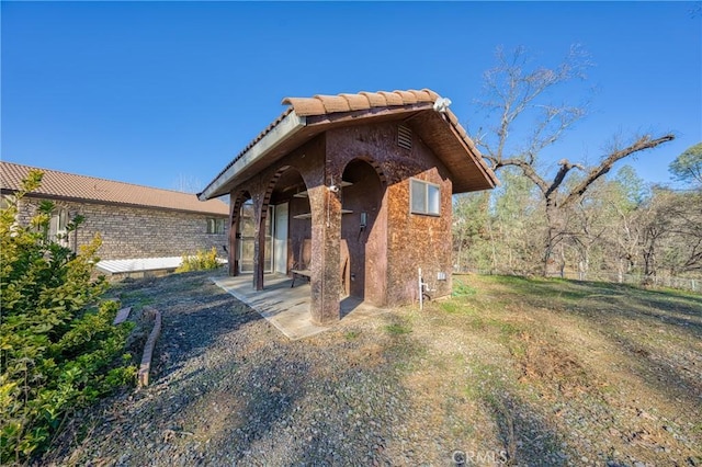 view of front of house featuring a tile roof and stucco siding