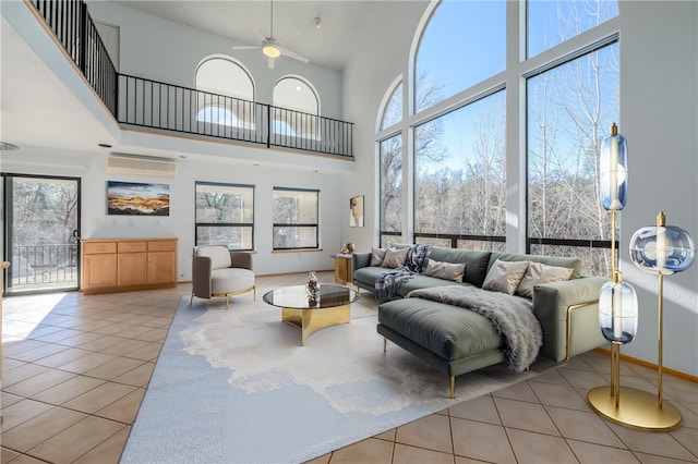 tiled living room with a towering ceiling, a wealth of natural light, and ceiling fan