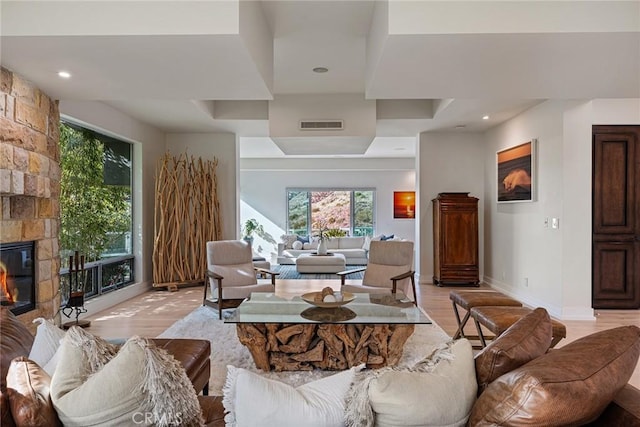 living room featuring light wood-type flooring and a fireplace