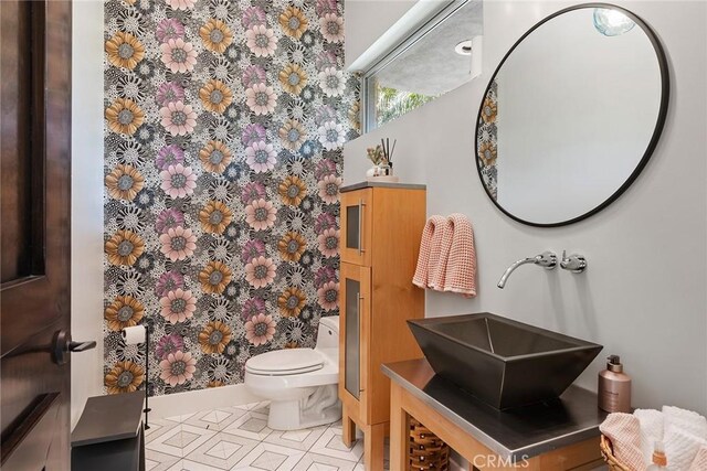 bathroom with vanity, tile patterned floors, and toilet