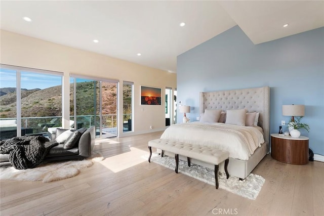 bedroom featuring a mountain view and light wood-type flooring