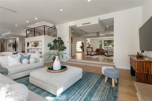 living room with light hardwood / wood-style flooring