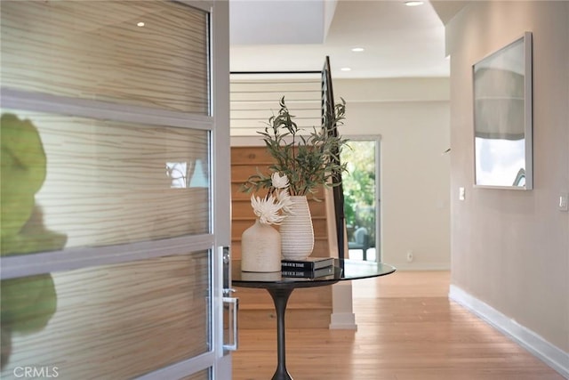 hallway with light hardwood / wood-style flooring