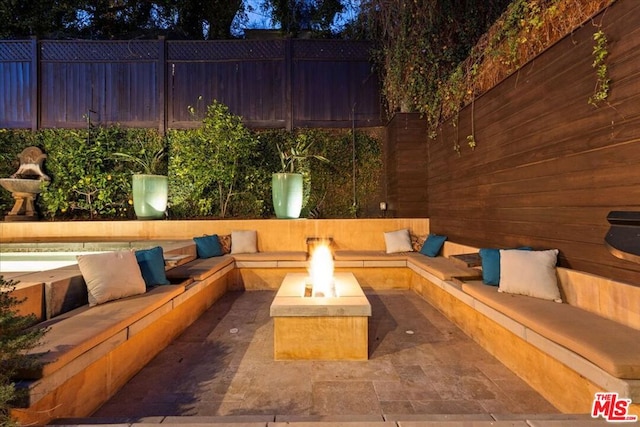 view of patio / terrace with an outdoor living space with a fire pit