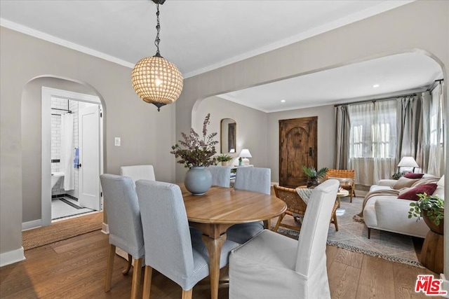 dining room featuring wood-type flooring and ornamental molding