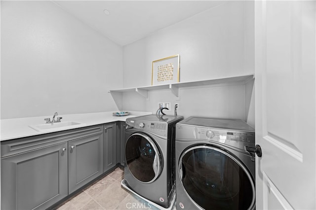 clothes washing area with cabinets, sink, and washing machine and dryer