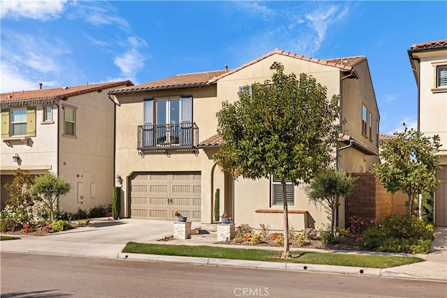 mediterranean / spanish-style home featuring a balcony and a garage