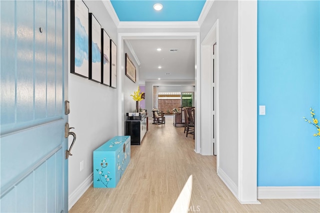 foyer featuring ornamental molding and light hardwood / wood-style floors