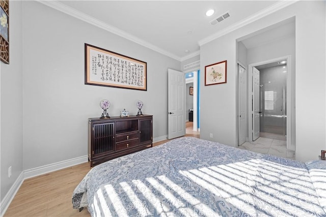 bedroom featuring crown molding, ensuite bathroom, and light wood-type flooring