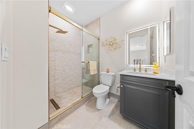 bathroom featuring vanity, a shower with shower door, tile patterned floors, and toilet