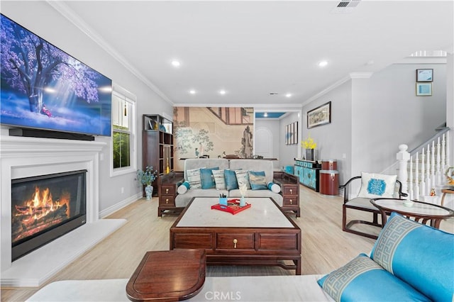 living room featuring crown molding and light hardwood / wood-style flooring