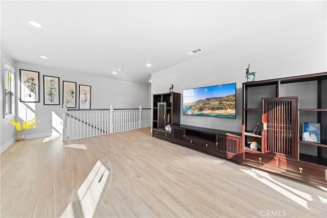 cinema room with light hardwood / wood-style floors