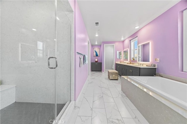 bathroom featuring vanity and shower with separate bathtub