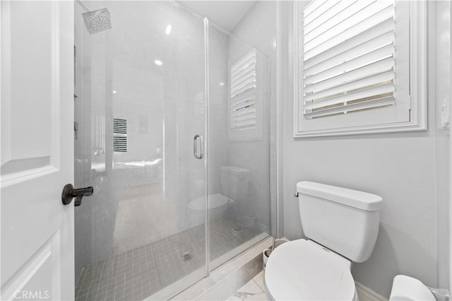 bathroom with walk in shower and toilet