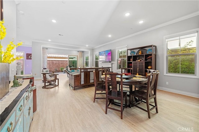 dining area with crown molding and light hardwood / wood-style floors