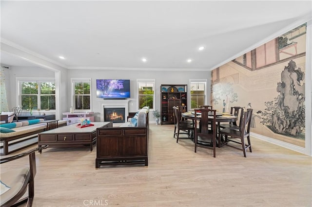 living room with ornamental molding and light wood-type flooring