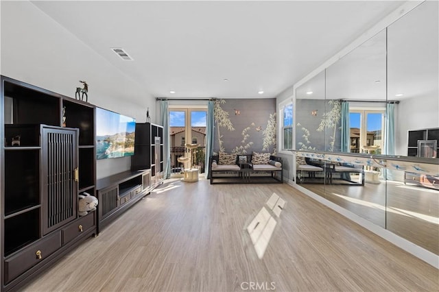 unfurnished living room with a wealth of natural light and light wood-type flooring