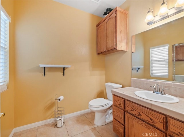 bathroom featuring tile patterned flooring, vanity, and toilet