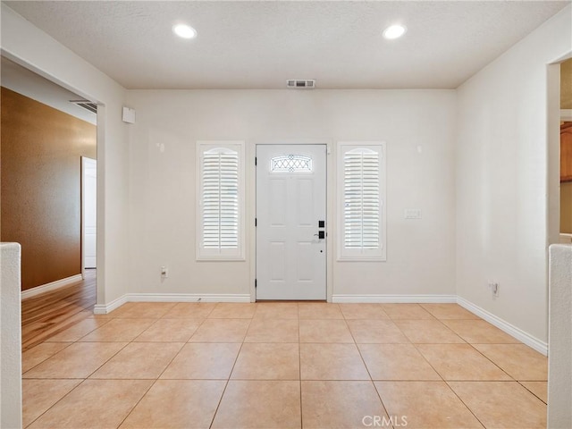 tiled foyer with a healthy amount of sunlight