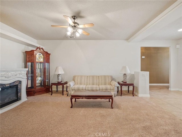 living room featuring light colored carpet, a textured ceiling, and ceiling fan