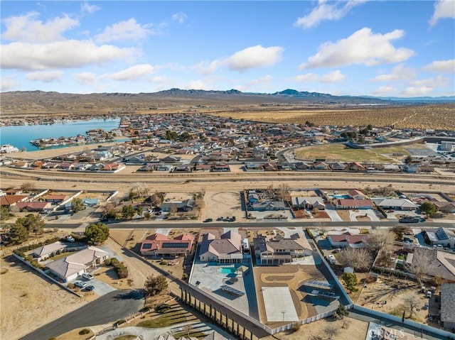 birds eye view of property with a water and mountain view