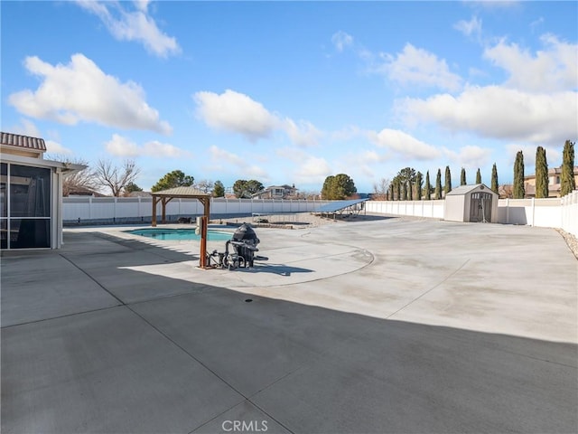 view of pool with a gazebo, a patio area, and a shed