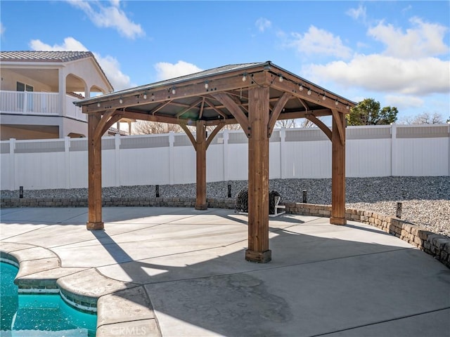 view of patio / terrace with a gazebo and a fenced in pool