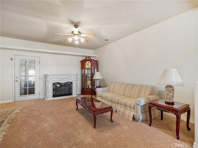 living room with ceiling fan and carpet flooring