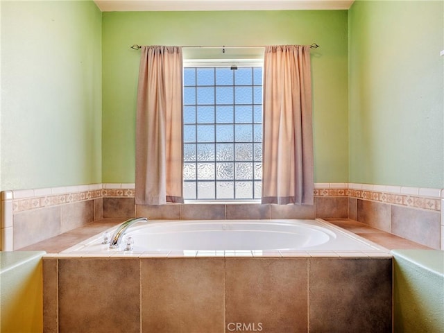 bathroom featuring tiled tub