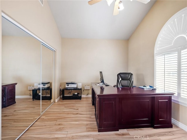 office area featuring vaulted ceiling, ceiling fan, and light hardwood / wood-style flooring