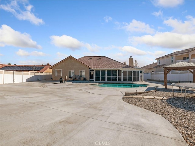 view of swimming pool with a gazebo, a sunroom, and a patio