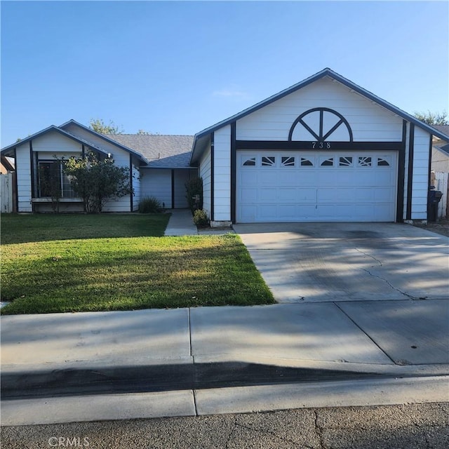 ranch-style home with a garage and a front yard