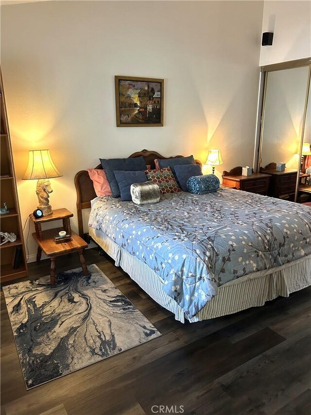 bedroom with dark hardwood / wood-style floors