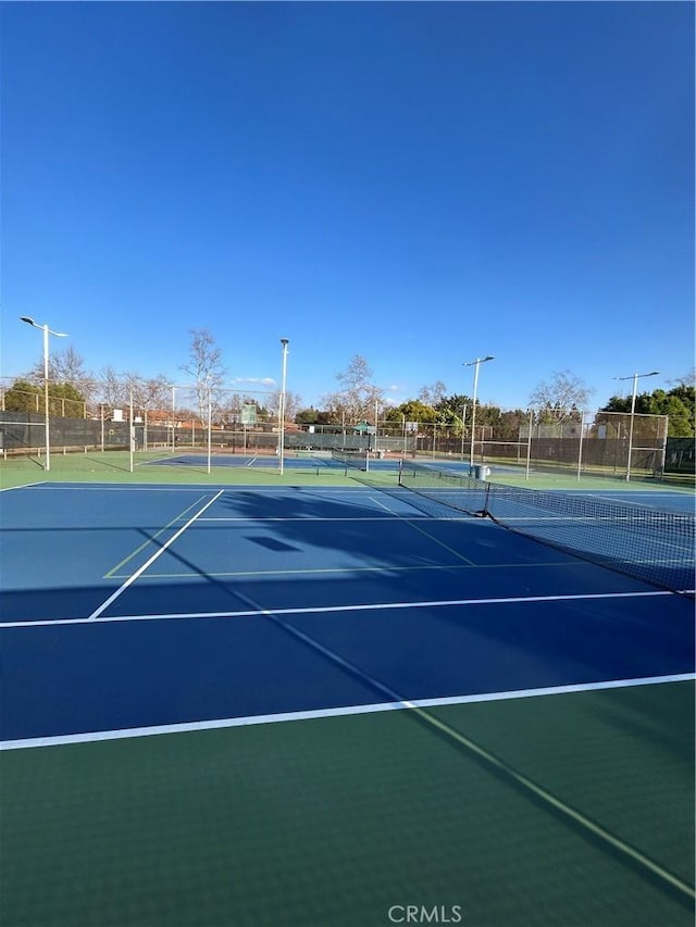 view of sport court with basketball hoop