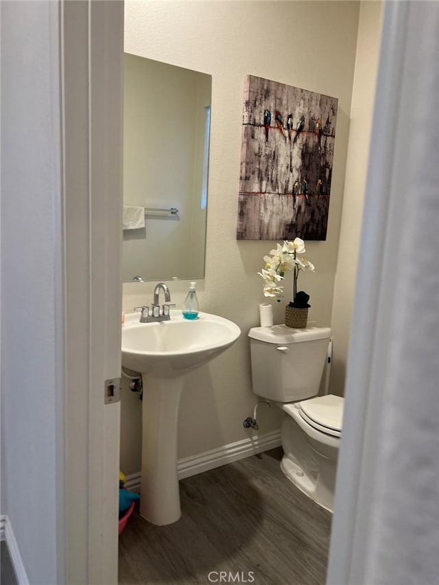 bathroom featuring hardwood / wood-style flooring, sink, and toilet