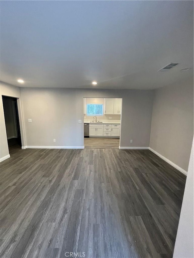 unfurnished living room with sink and dark hardwood / wood-style flooring