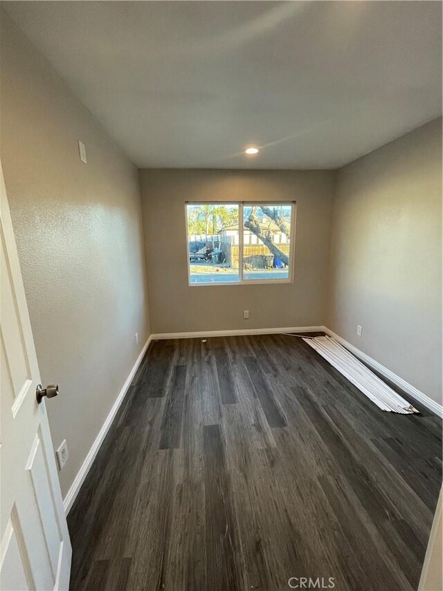 unfurnished room featuring dark hardwood / wood-style flooring