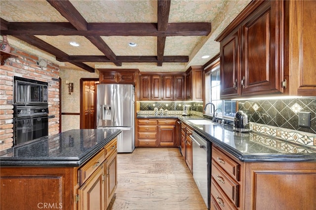 kitchen featuring backsplash, light wood-type flooring, sink, and black appliances