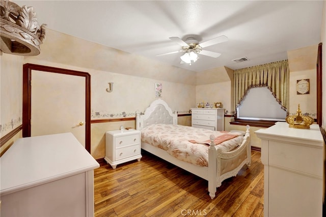 bedroom with ceiling fan and wood-type flooring