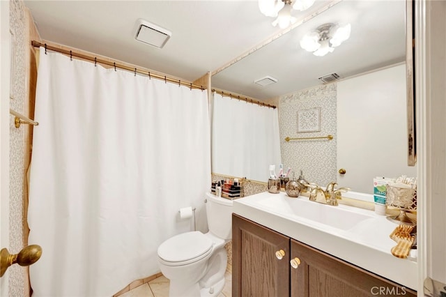 bathroom with tile patterned flooring, vanity, and toilet