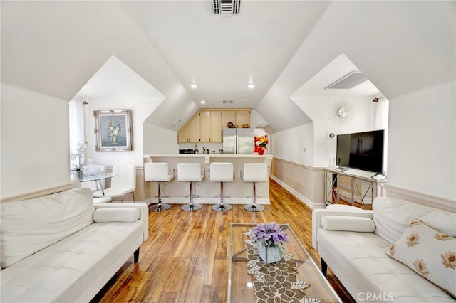 living room with vaulted ceiling and light hardwood / wood-style flooring