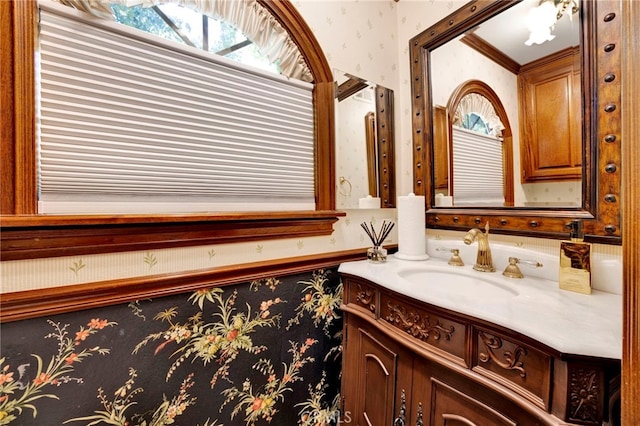 bathroom featuring vanity and ornamental molding